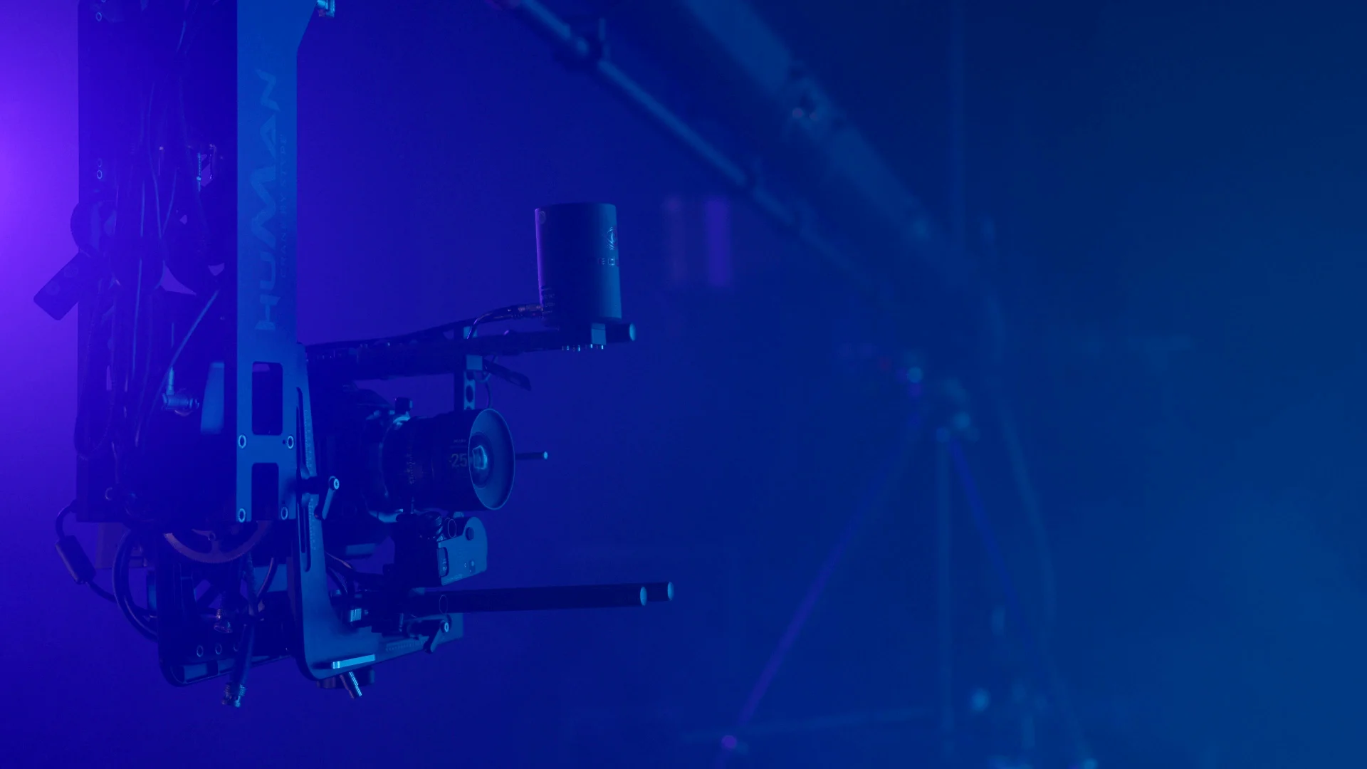Camera crane in purple-blue studio light
