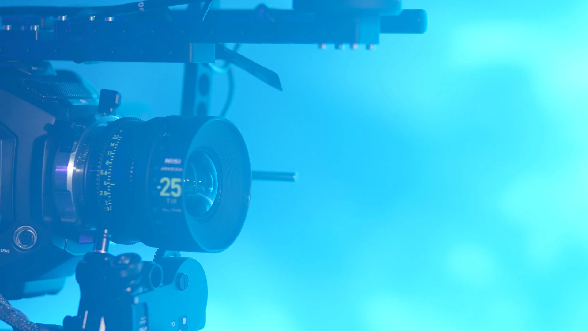 Cinema camera lens in cyan studio light