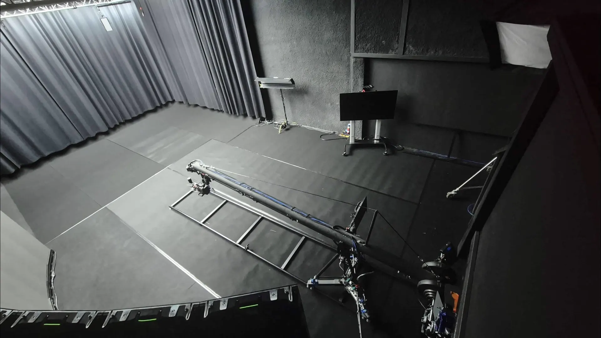 High-angle view of the empty studio, showing the camera crane and truss structures.