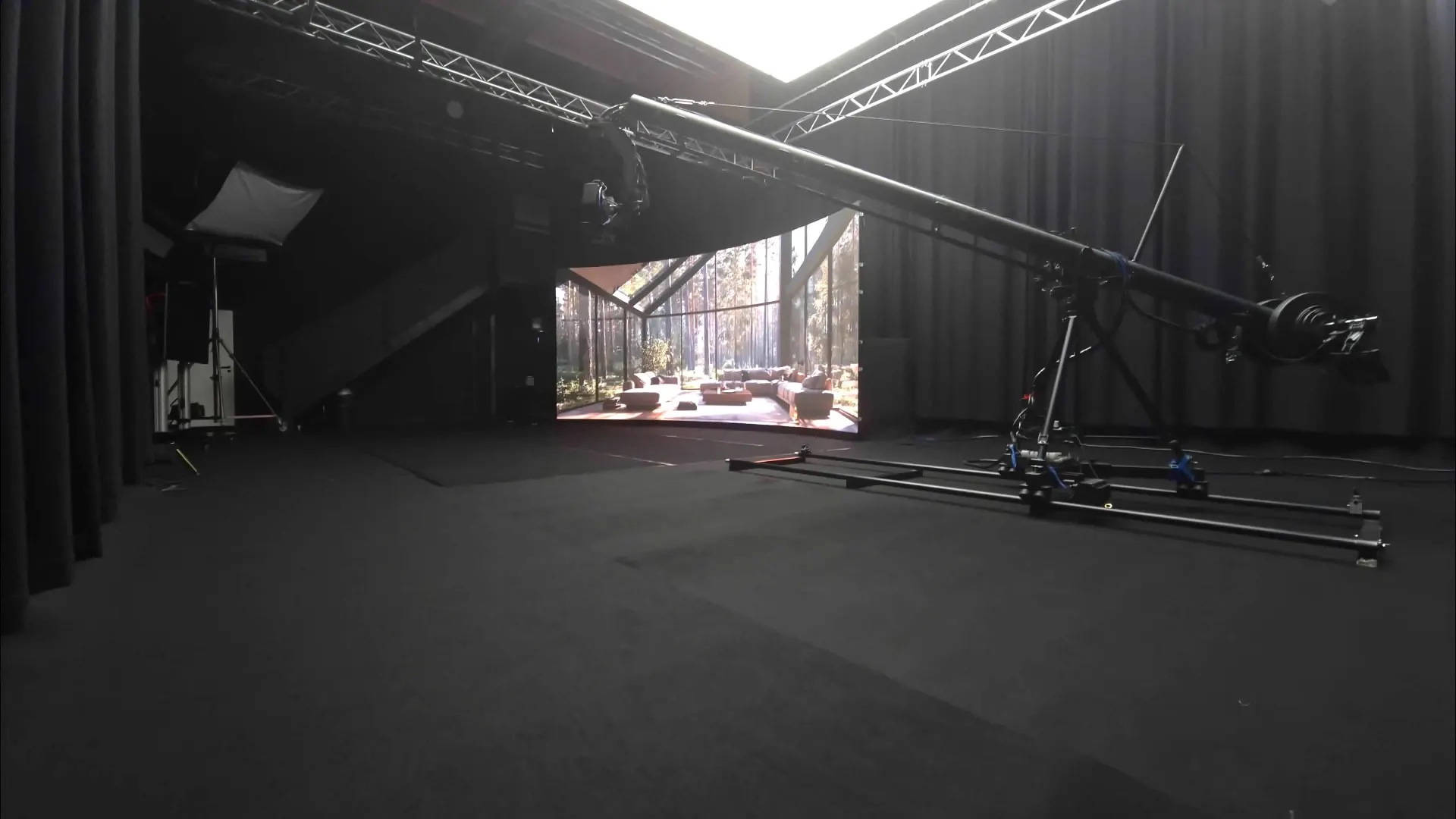 Expansive LED set with a forest house view and a camera crane.